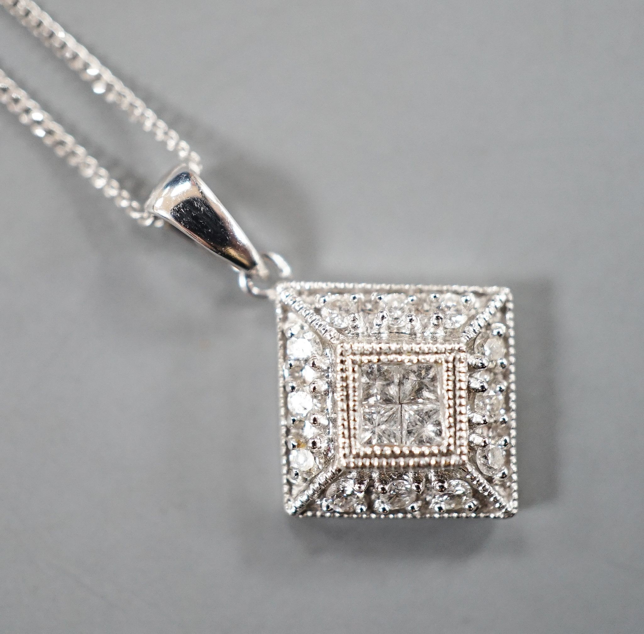 A modern 9k and diamond chip set pendant, 10mm, on a 585 fine link chain, 44cm, gross weight 2.1 grams.